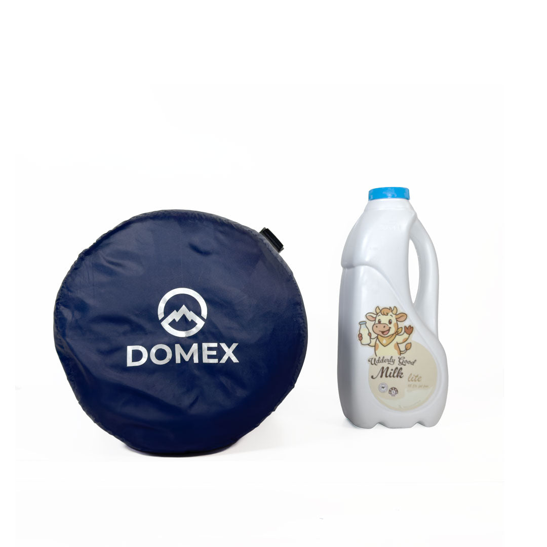 Scale image of top of compression sack for Domex Trailblazer 500 XT 3-season down bag next to 1 litre bottle of milk