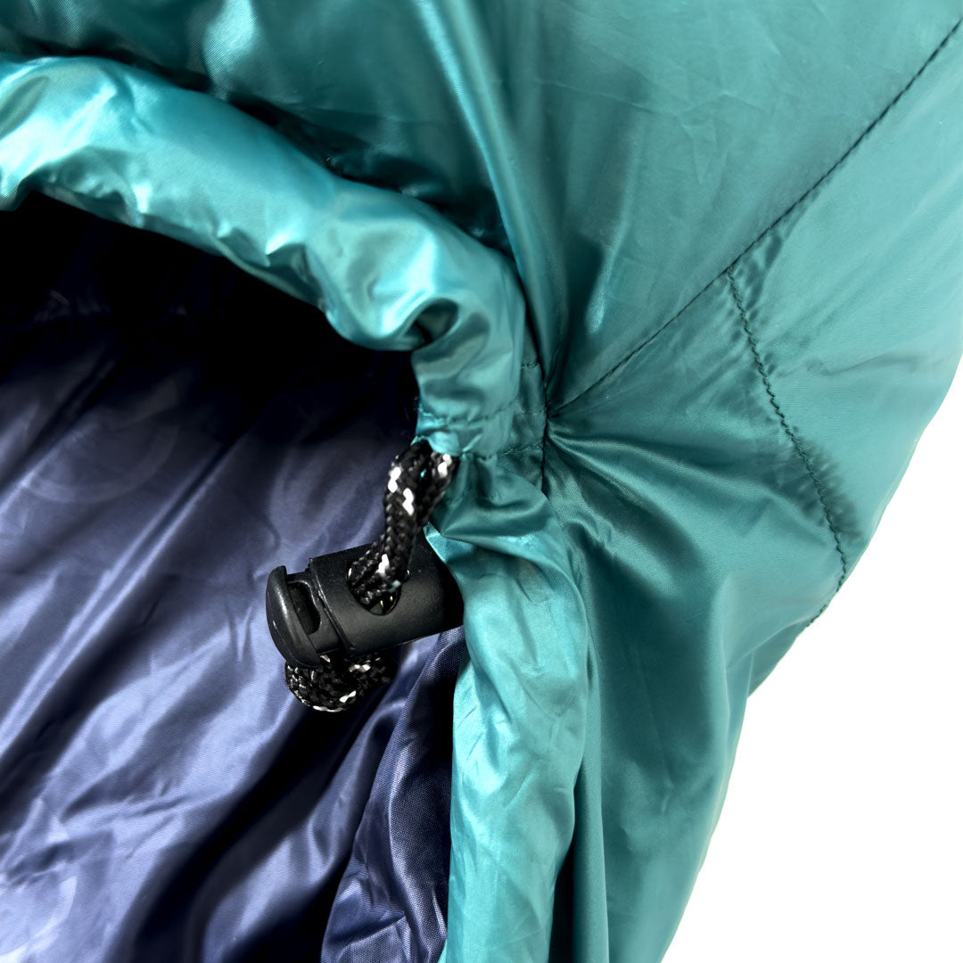 Close up of toggle of Domex Wanderer 300 - 2-season down bag - teal with navy lining