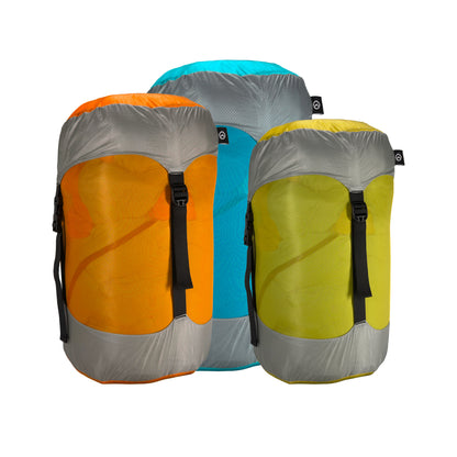 Three Domex compression sacks - Teal and Grey, Orange and Grey, Blue and Grey